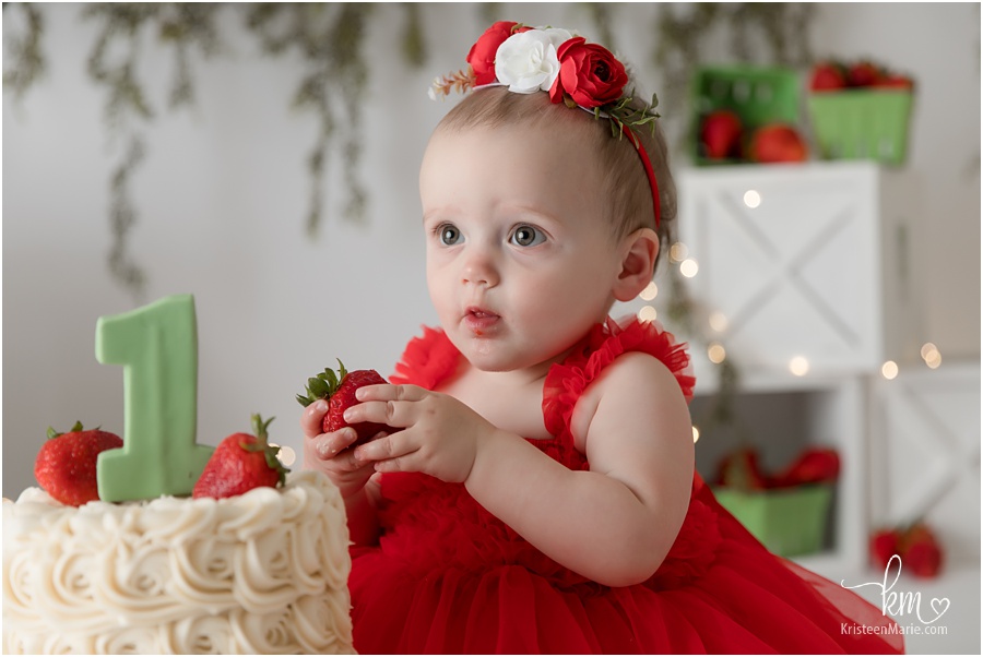 little one eating strawberryy