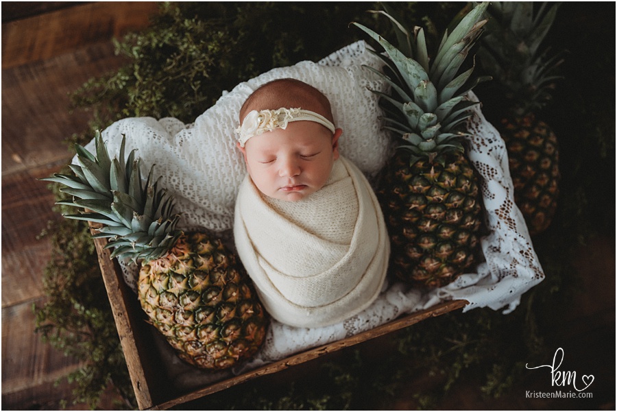newborn baby with pineapples