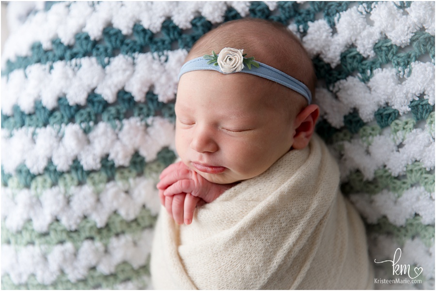 newborn girl on hand knit blanket