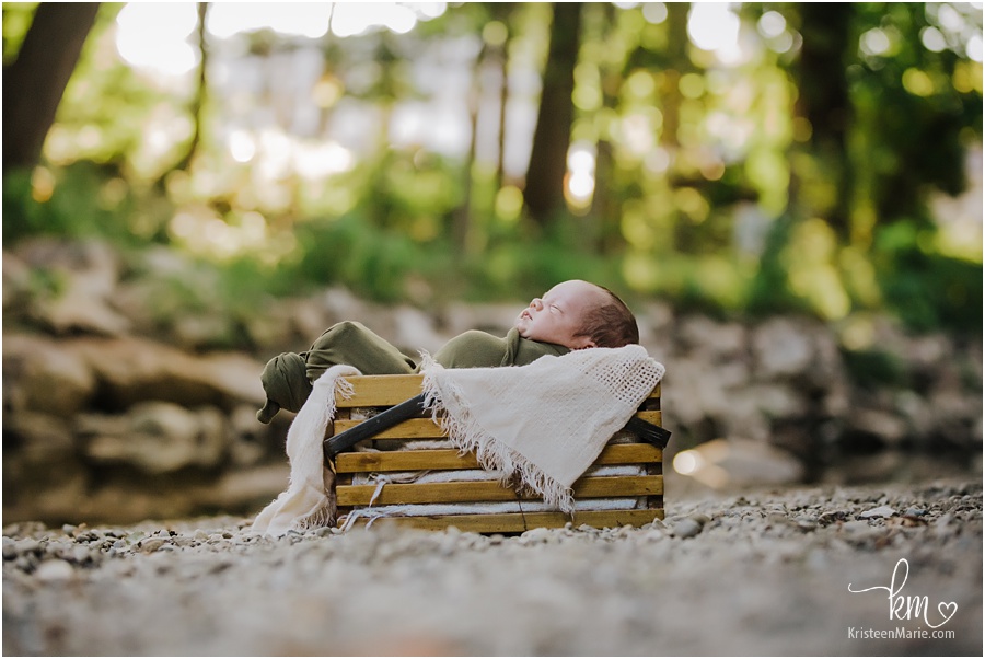 Outdoor newborn photography - baby in a basket