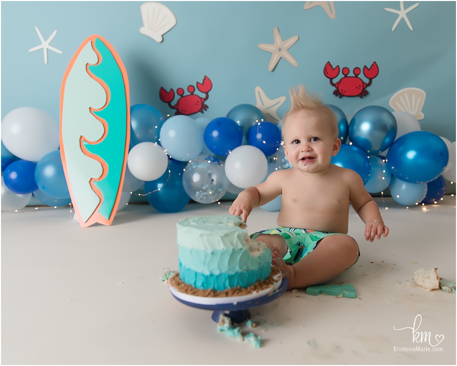 Happy birthday boy during surf cake smash session