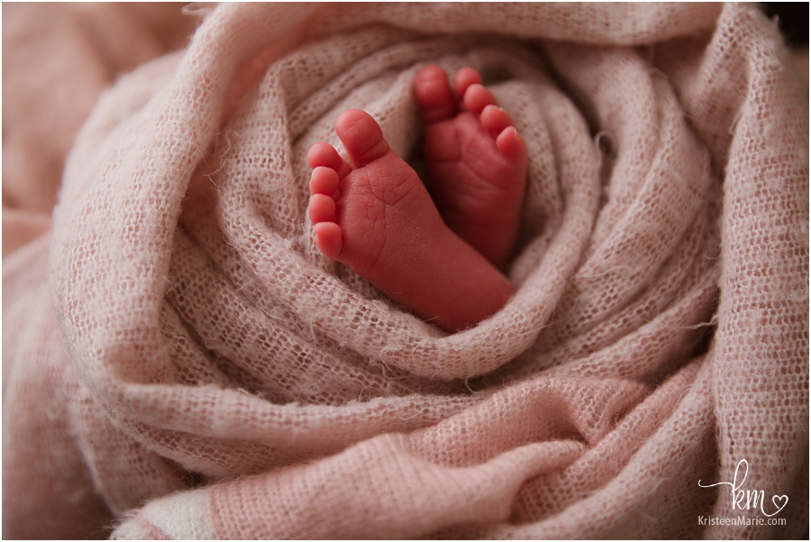 newborn baby feet in pink wrap