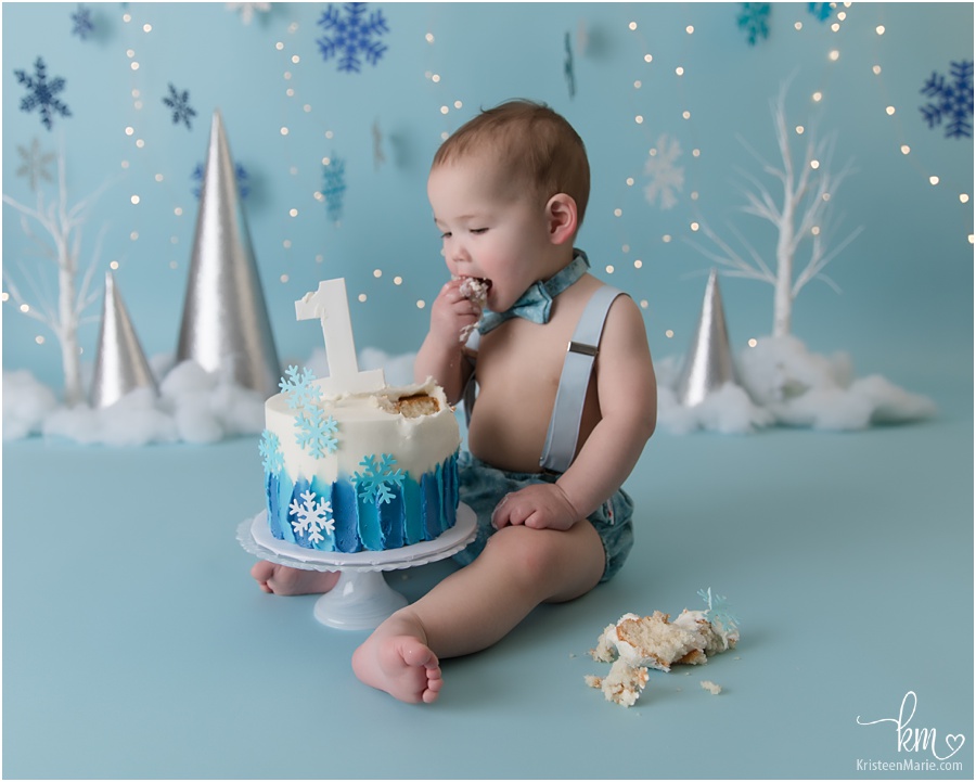 birthday boy eating birthday cake - blue and white winter themed session