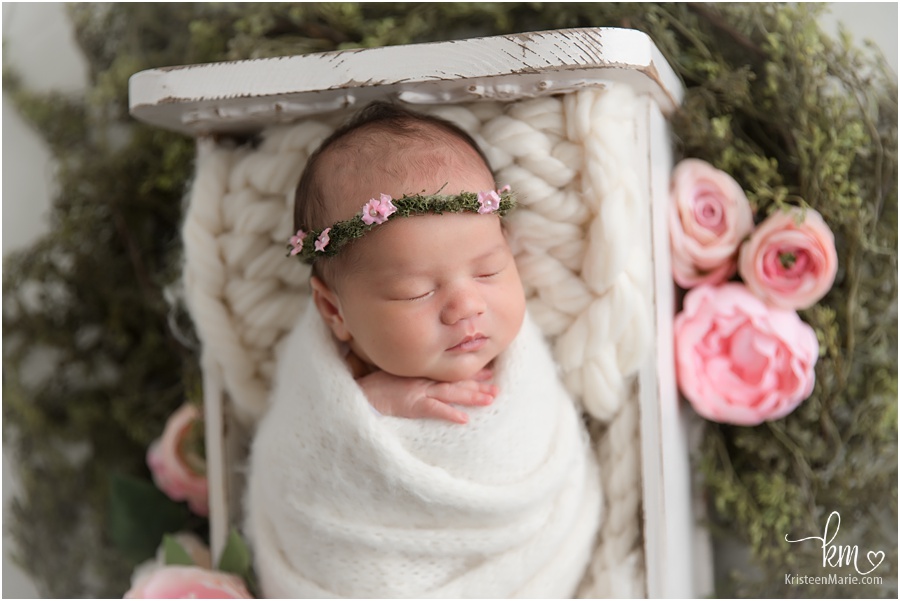newborn girl with pink flowers