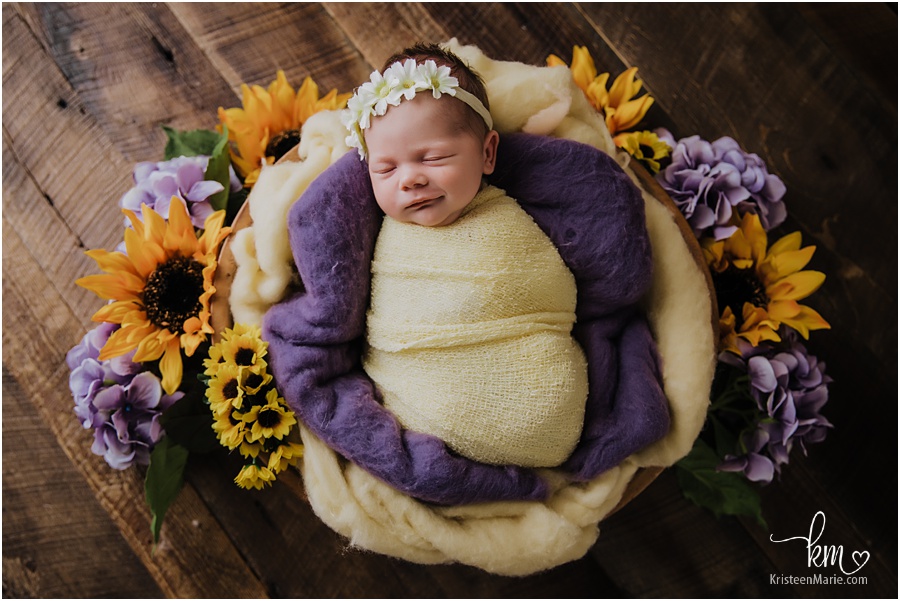 newborn girl in purple and yellow - sunflowers and hydrangeas