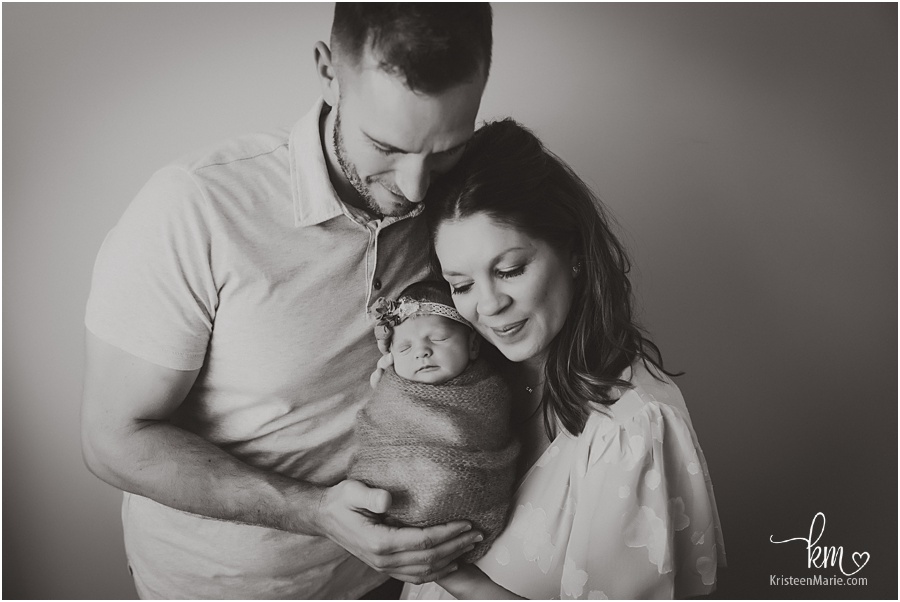family with newborn girl in black and white image