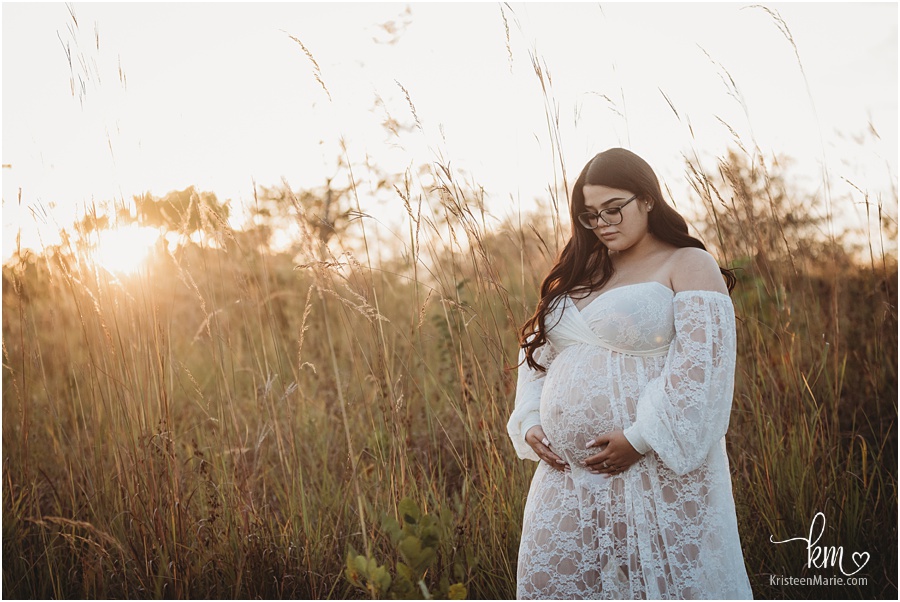 expecting mom in white maternity dress at sunset
