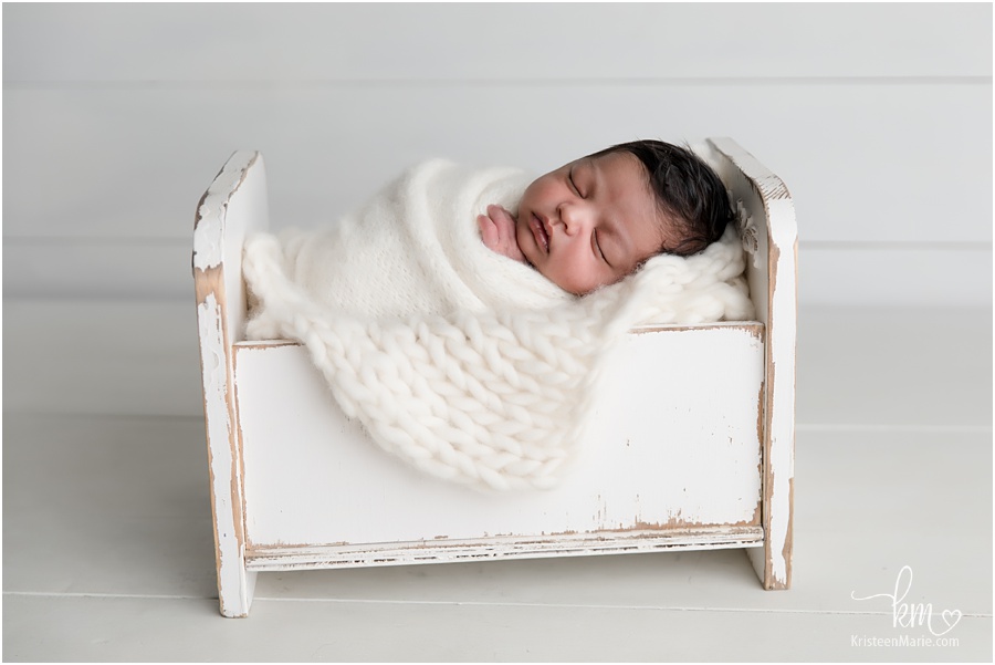 sleeping newborn boy in crib