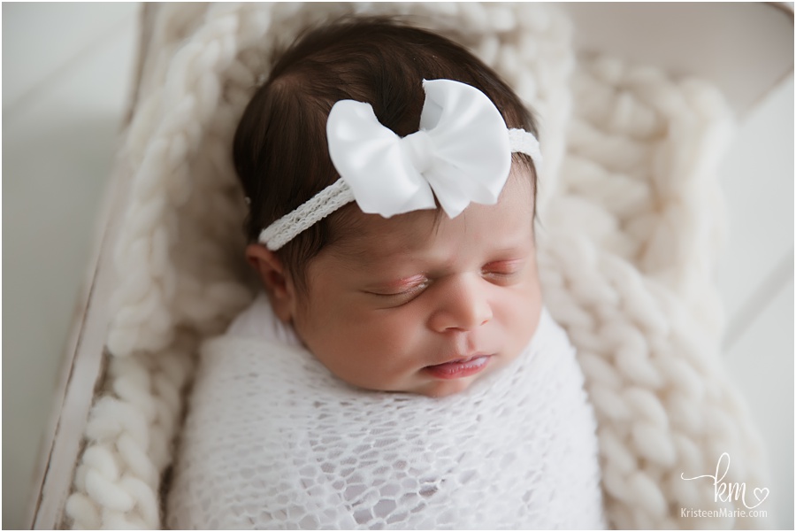 baby girl with white bow