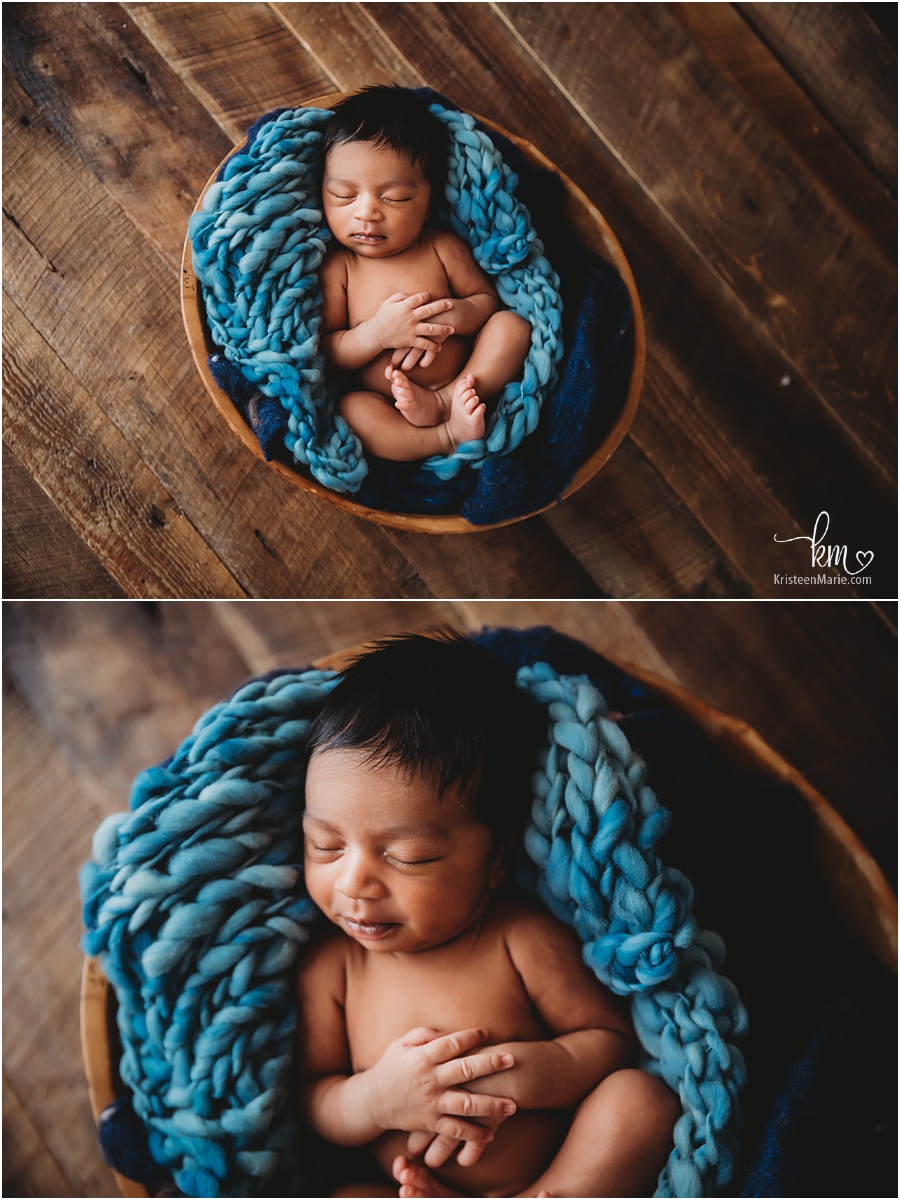 newborn boy in bowl wiht blue fluff