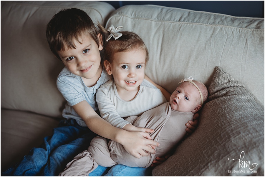 three siblings - one is a newborn baby girl