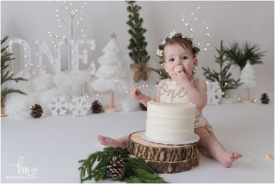baby girl taking bite of cake