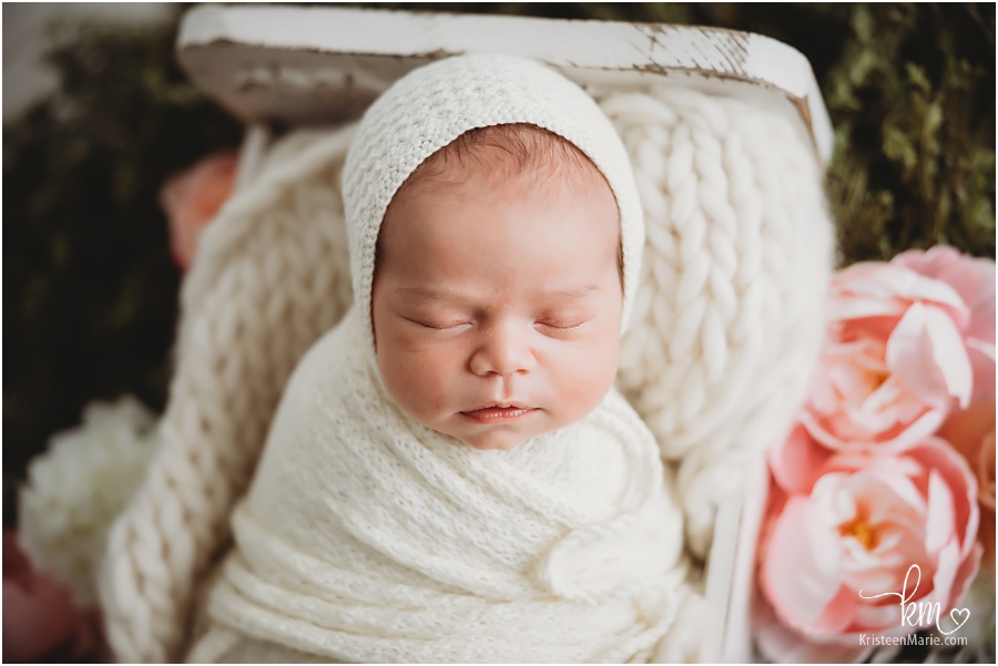 newborn girl with bonnet