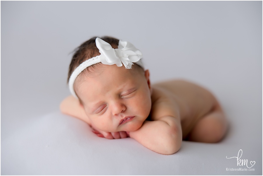 Sleeping newborn girl on white