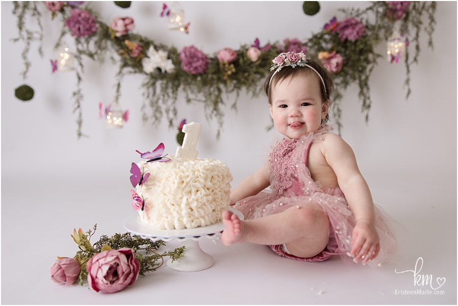 Mauve Floral first birthday cake smash session with greenery and butterfly 