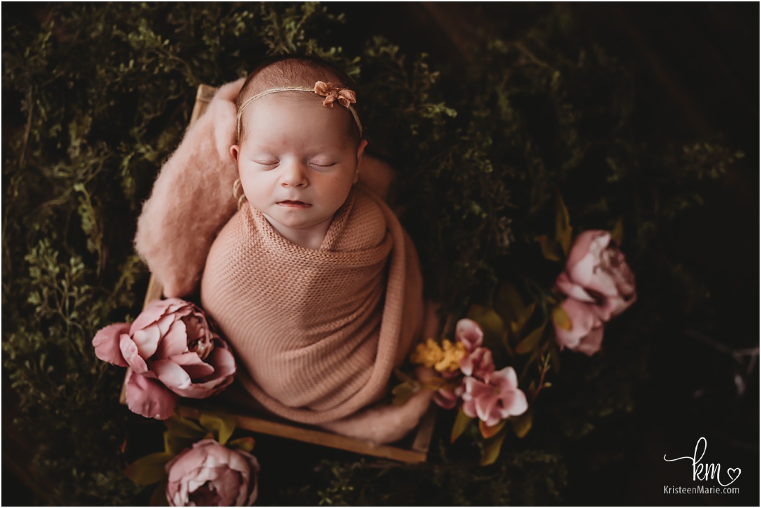 rustic image of newborn baby girl and pink flowers - Indianapolis newborn photography