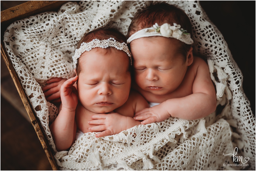 newborn girls wrapped in vintage lace