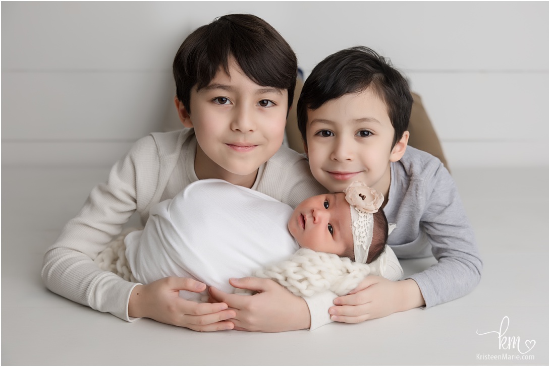 big brothers holding new newborn baby sister - Indianapolis newborn photography