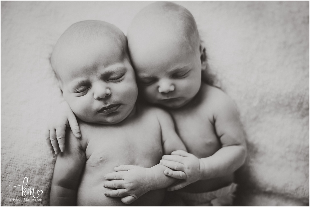 black and white images of twin newborn boys cuddling