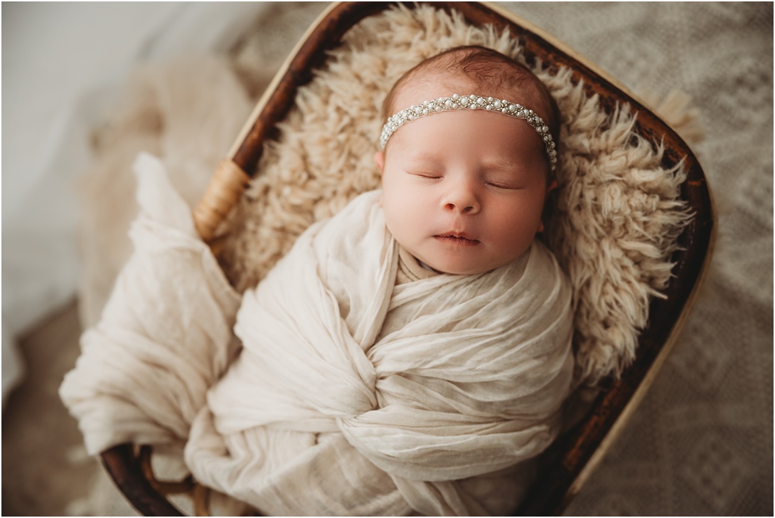 newborn baby girl in boho basket