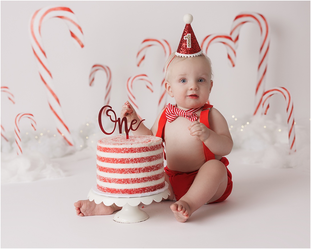 birthday boy smiling during candy cane themed smash cake session