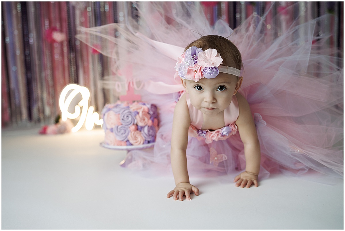 1 year old girl crawling away from birthday cake