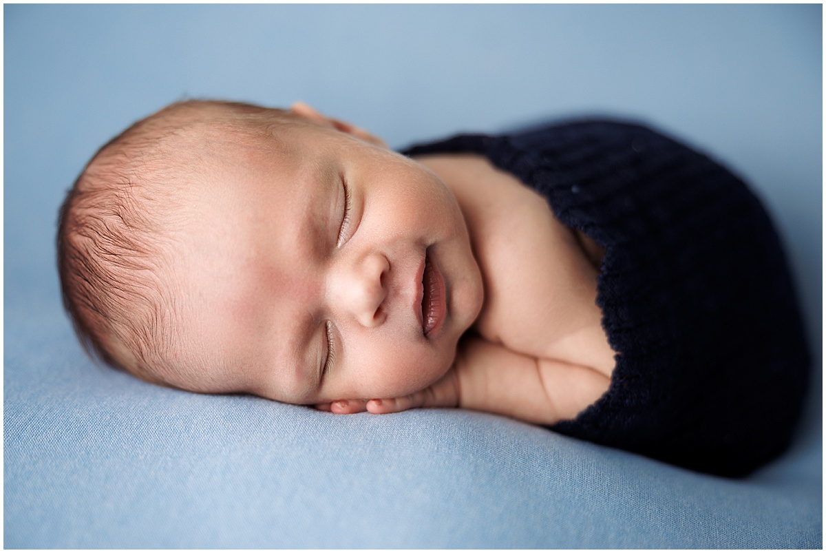 smiles from sleeping newborn boy