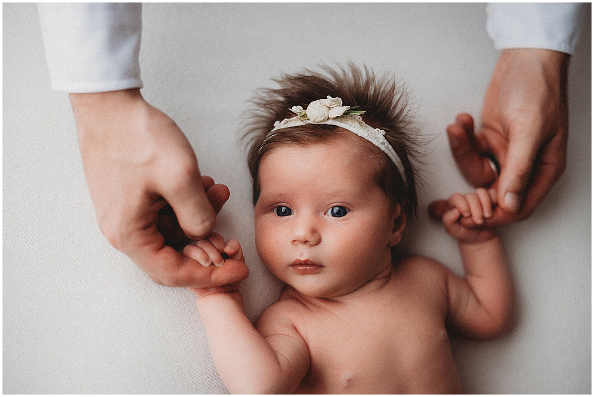 Westfield Indiana Newborn Photography - dad holding baby girl's hands