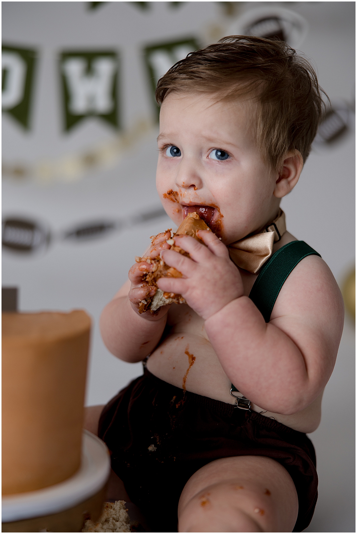 Baby eating a big piece of cake