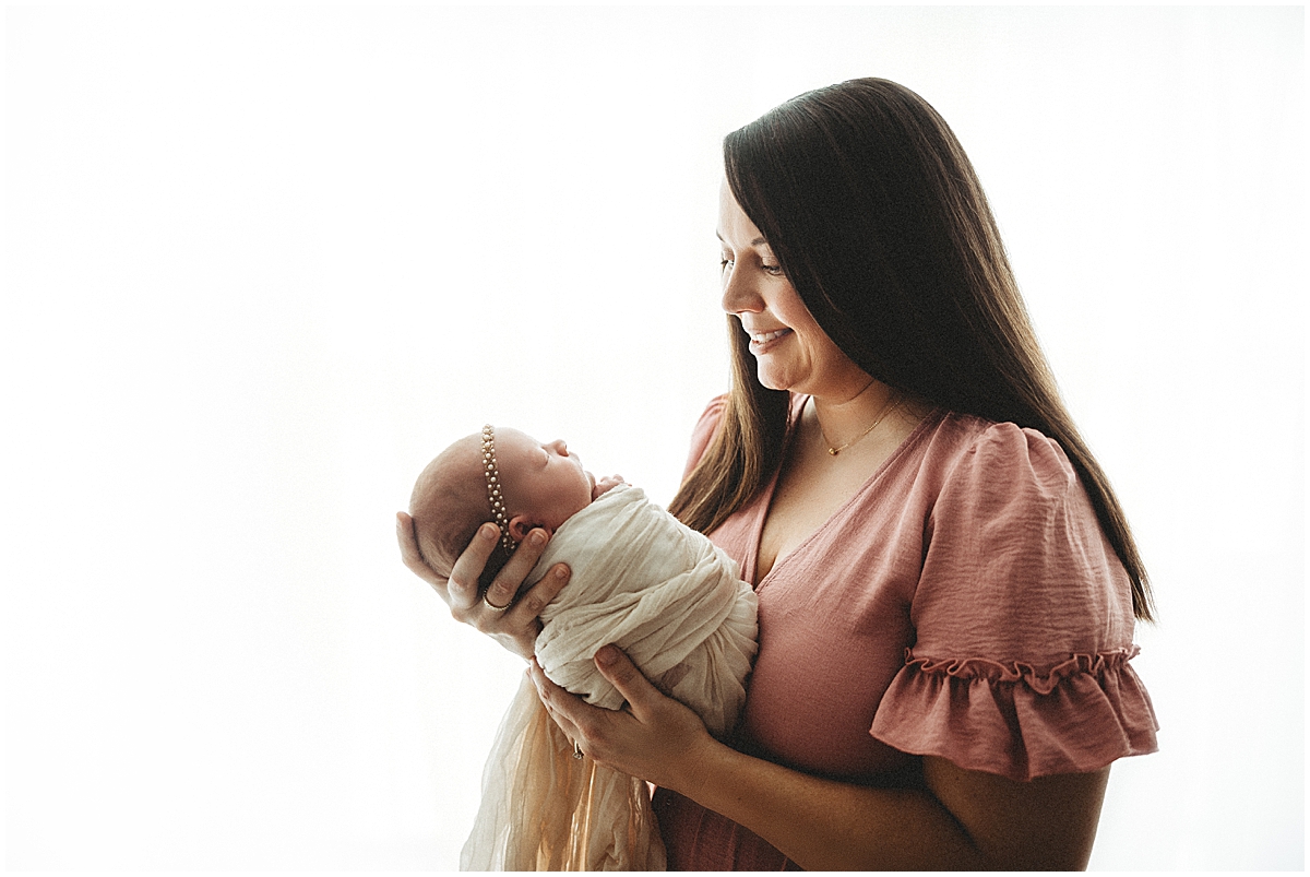 Mom holding newborn baby girl