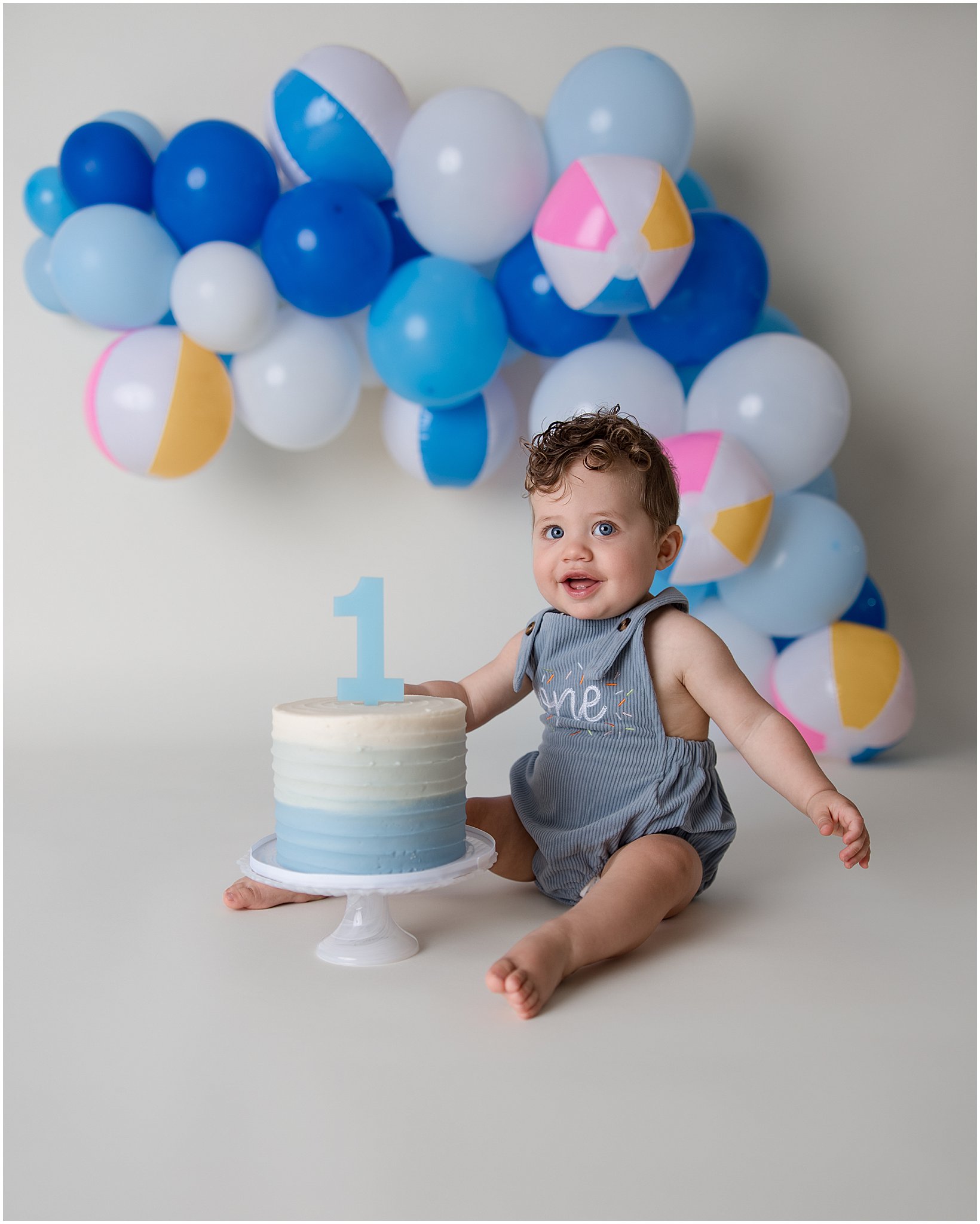 Baby boy smiling during beach ball themed cake smash – Indianapolis Photographer
