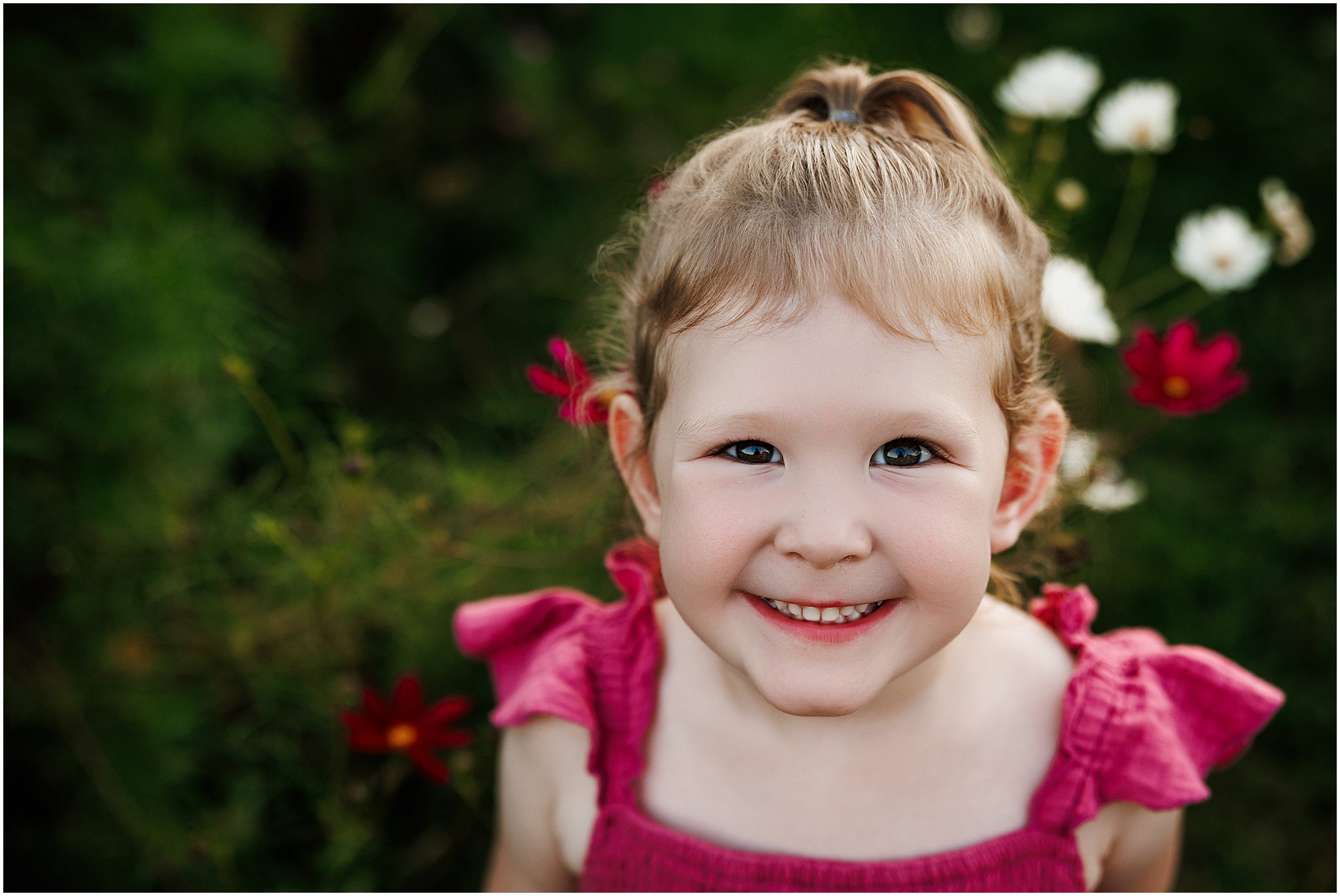 sweet smiling girl in wildflower field