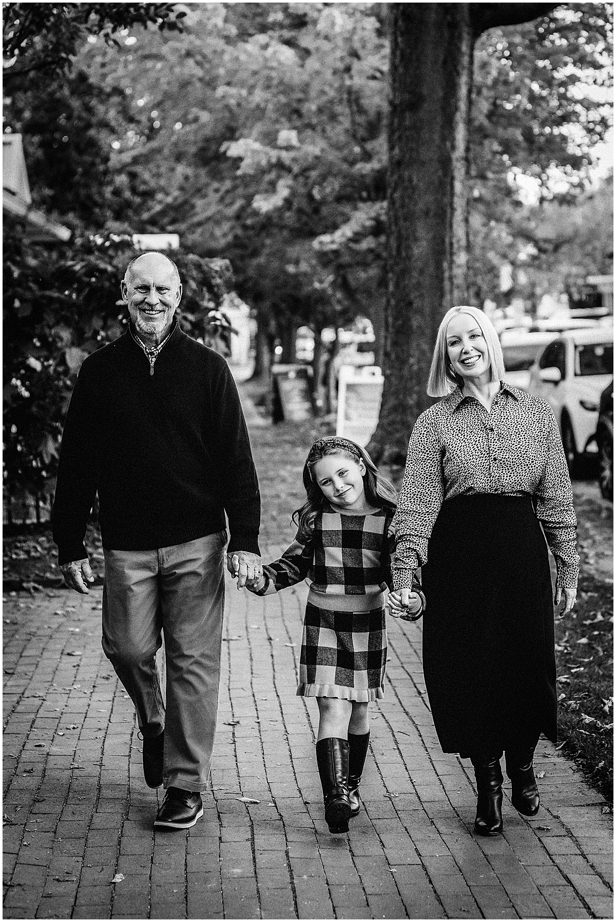 black and white image of family walking down main street in Zionsville