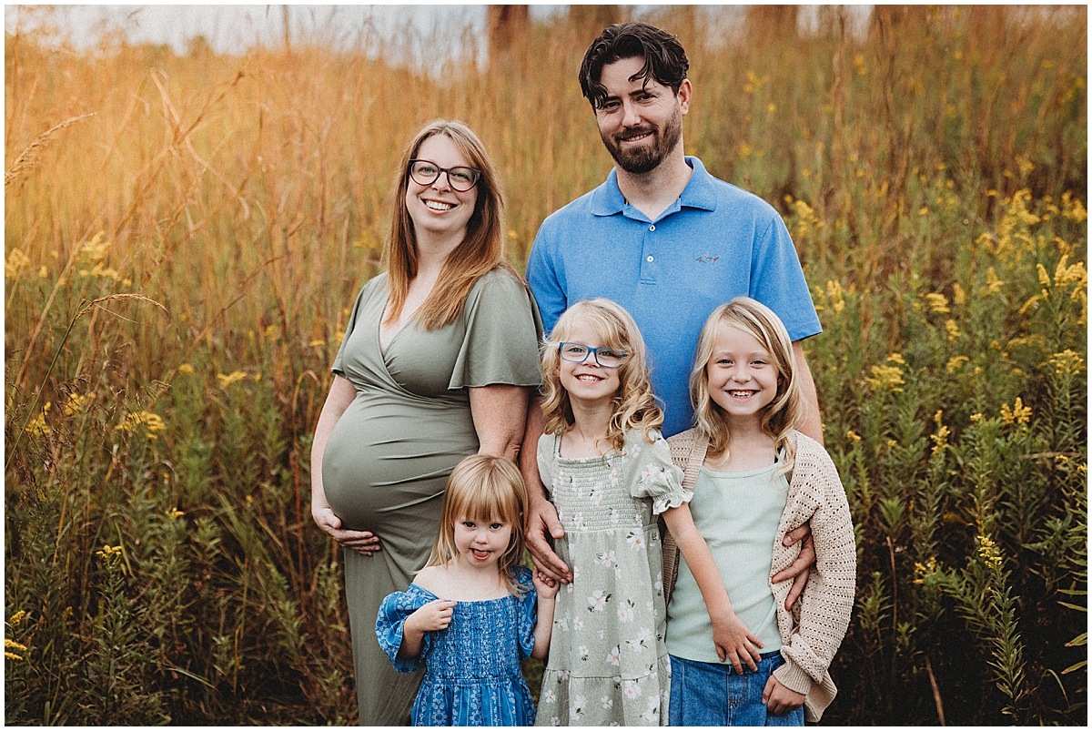 Carmel maternity photographer at Central Park with expecting mom, dad, and three daughters