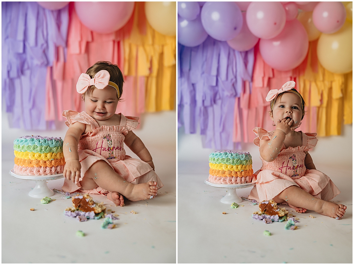 Rainbow cake smash session with baby girl tasting frosting and celebrating her first birthday in an Indianapolis photography studio