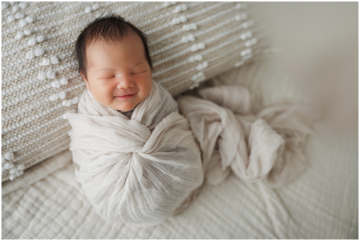 Seeping newborn baby boy with big smile on his face - Indianapolis newborn photography by KristeenMarie