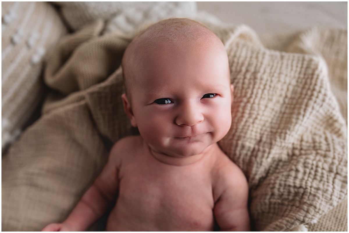 awake newborn smirks