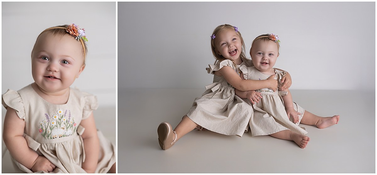 First birthday portrait of a girl in a neutral dress beside a portrait with her laughing older sister.